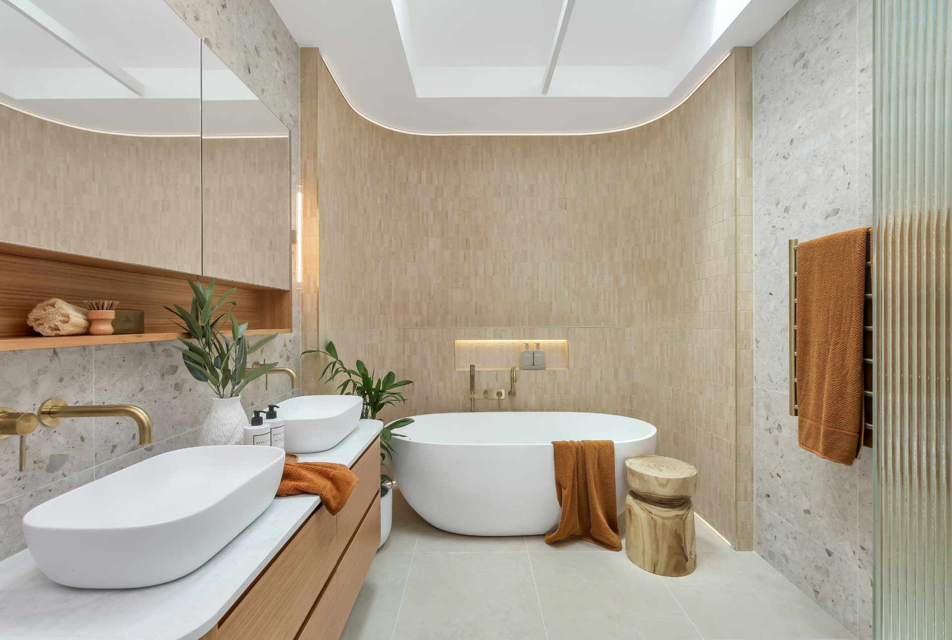 Designer bathroom with freestanding bath and brass tapware — real estate photography by Estate Media Co