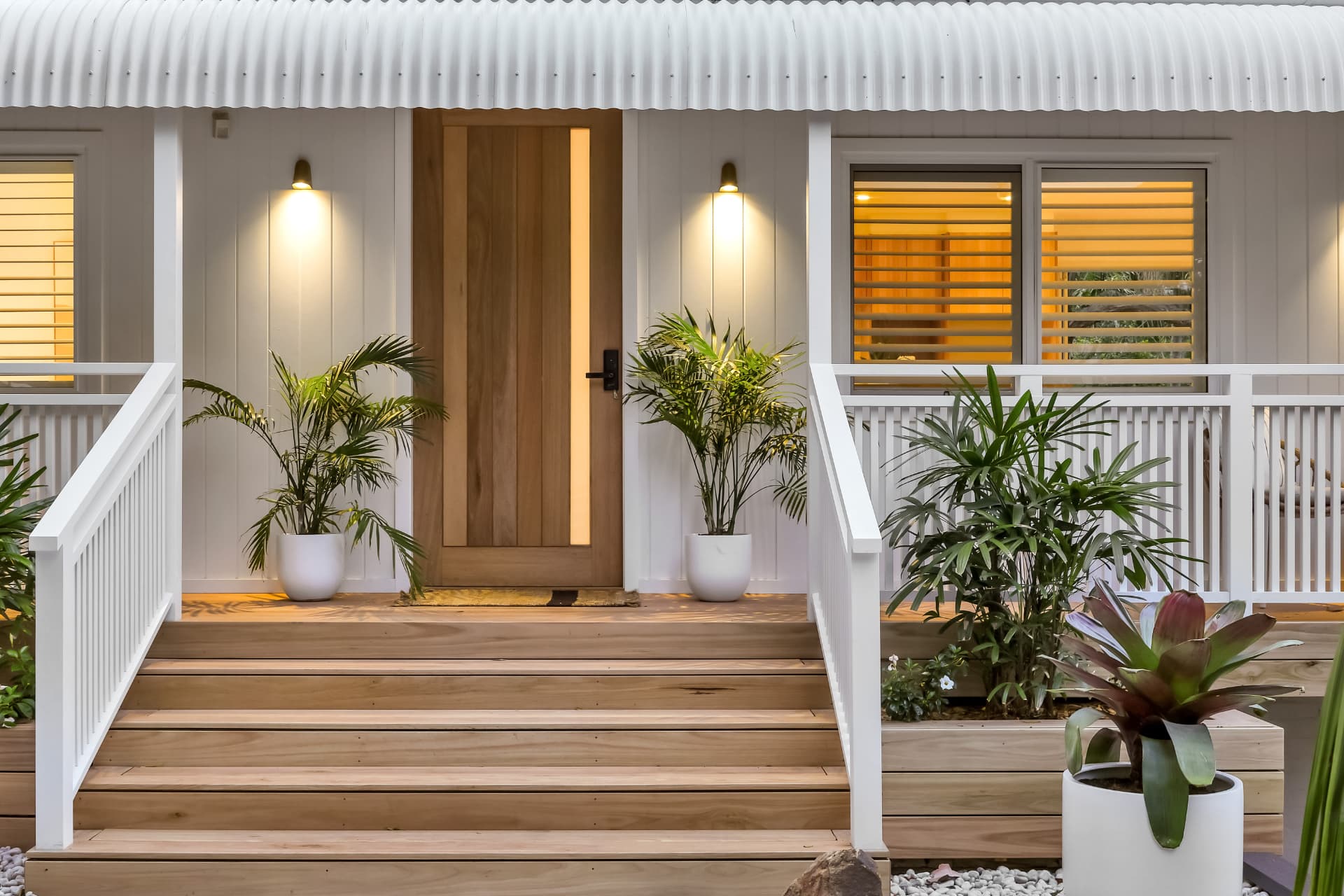 Coastal home entry at dusk with warm lighting — real estate photography by Estate Media Co