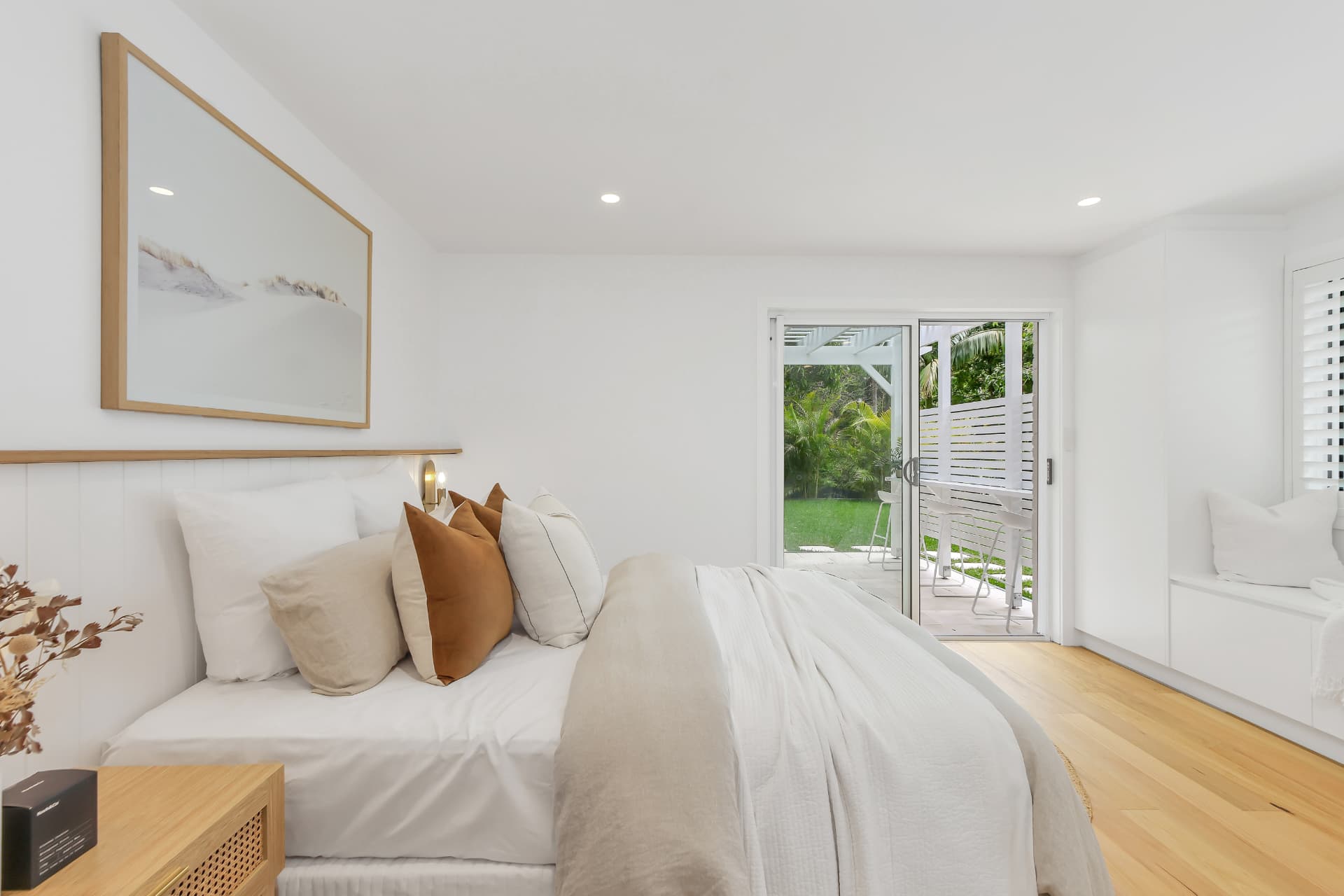 Light-filled master bedroom opening to a garden — real estate photography by Estate Media Co
